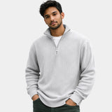 White ribbed quarter-zip sweater with long sleeves and half-zip collar