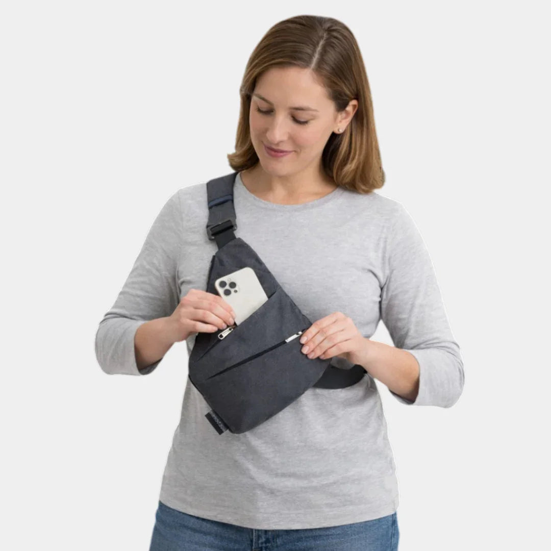 Gray anti-theft crossbody bag on model, front pocket and strap visible
