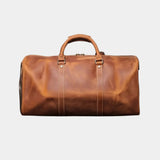 Caramel leather travel bag with top handle, front seams, and metal clasp