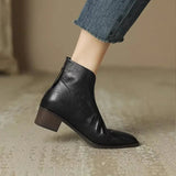 Black leather ankle boots with low block heel and V-shaped side opening