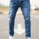 Slim-fit ripped jeans in light blue, distressed knee patches and top button