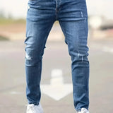 Slim-fit ripped jeans in light blue, distressed knee patches and top button