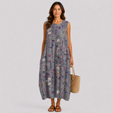 Floral sleeveless summer dress with gathered skirt, round neckline, dark gray base.