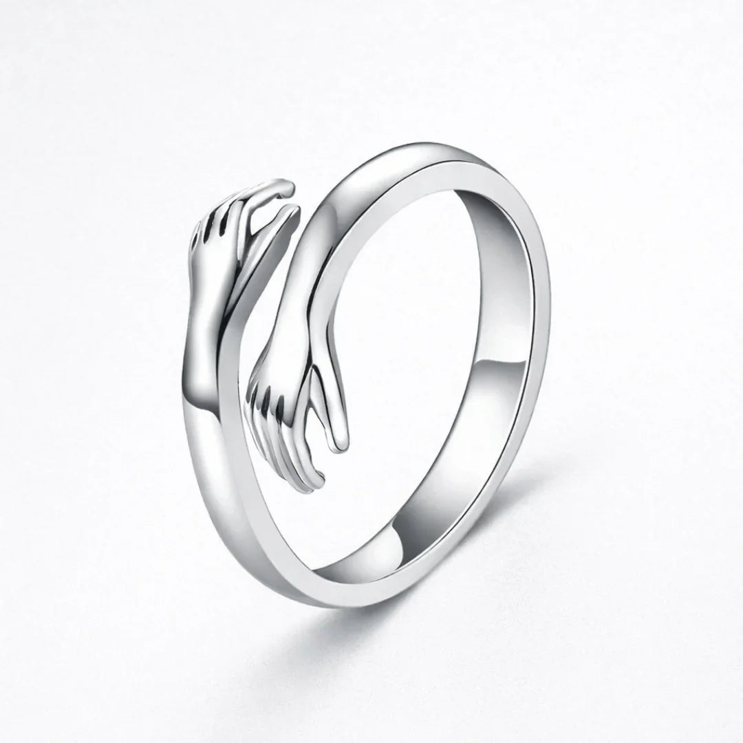 Silver embrace ring with open top and sculpted wave detail