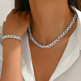 Silver fish tail link necklace and matching bracelet, shown on model
