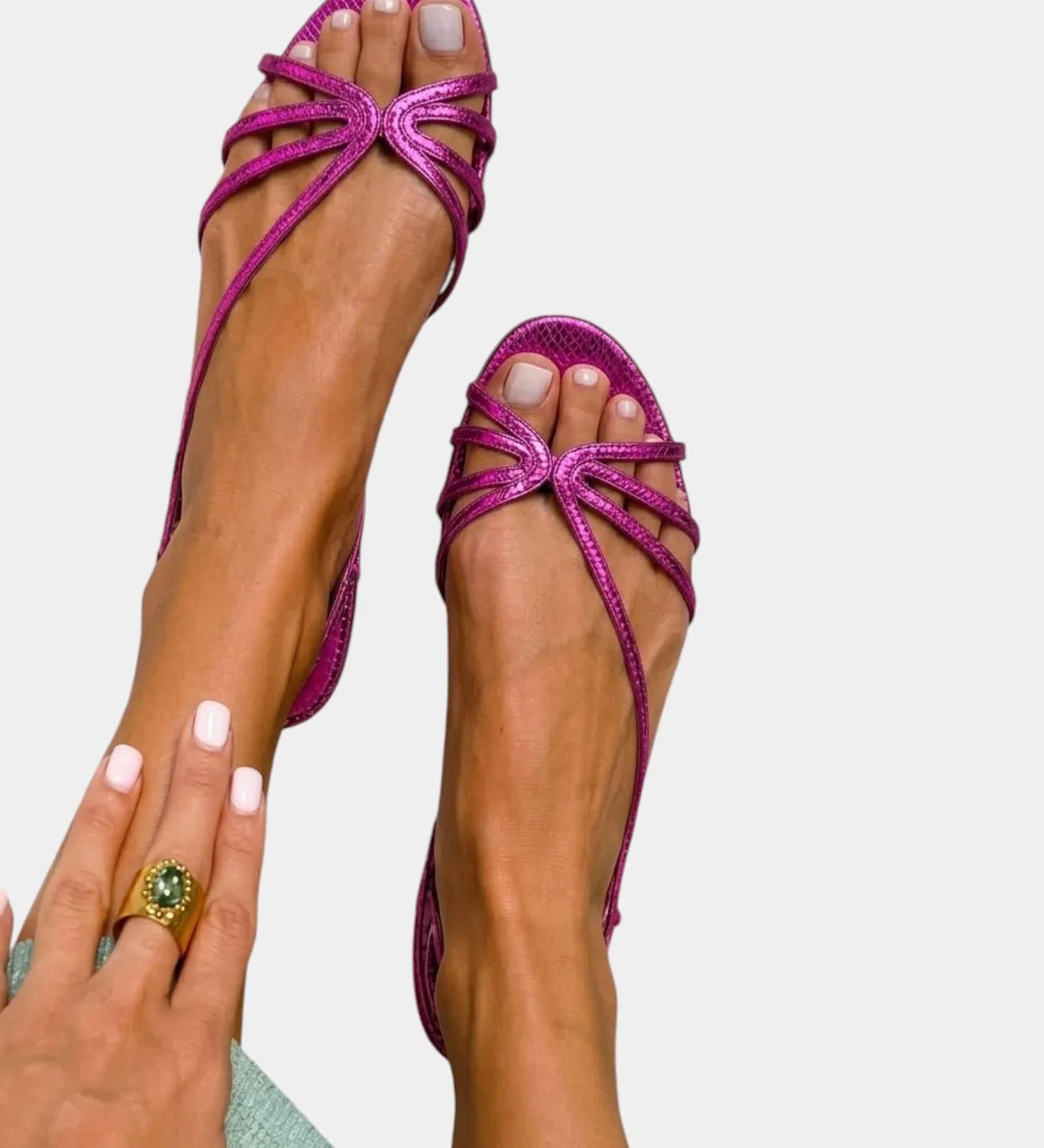Purple strappy sandals with jeweled starburst bow and open toe.