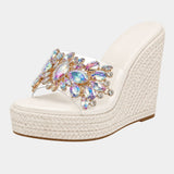White heeled platform sandals with multicolor jeweled floral strap and woven wedge