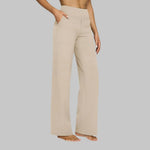 Cream wide-leg pants with high-rise waist and side pockets, relaxed straight legs.