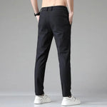 Men's black slim-fit dress pants with belt loops and tapered leg