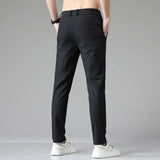 Men's black slim-fit dress pants with belt loops and tapered leg