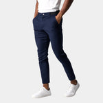 Navy chino pants with button fly, front pockets, and tapered ankle length.