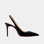 Shiny black pointed-toe slingback heels with high stiletto heel and visible red sole edge