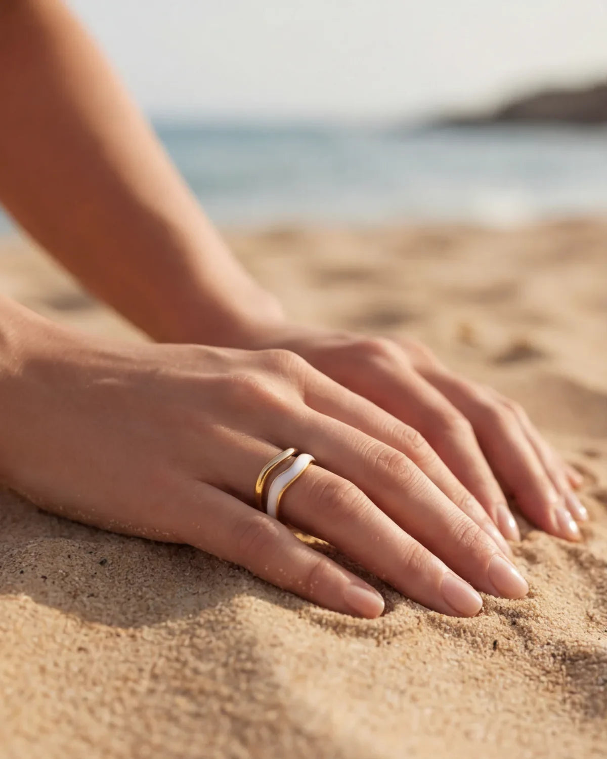 Adjustable gold ring with white inlay stripe, worn on finger