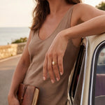 Gold oval-pearl ring on finger