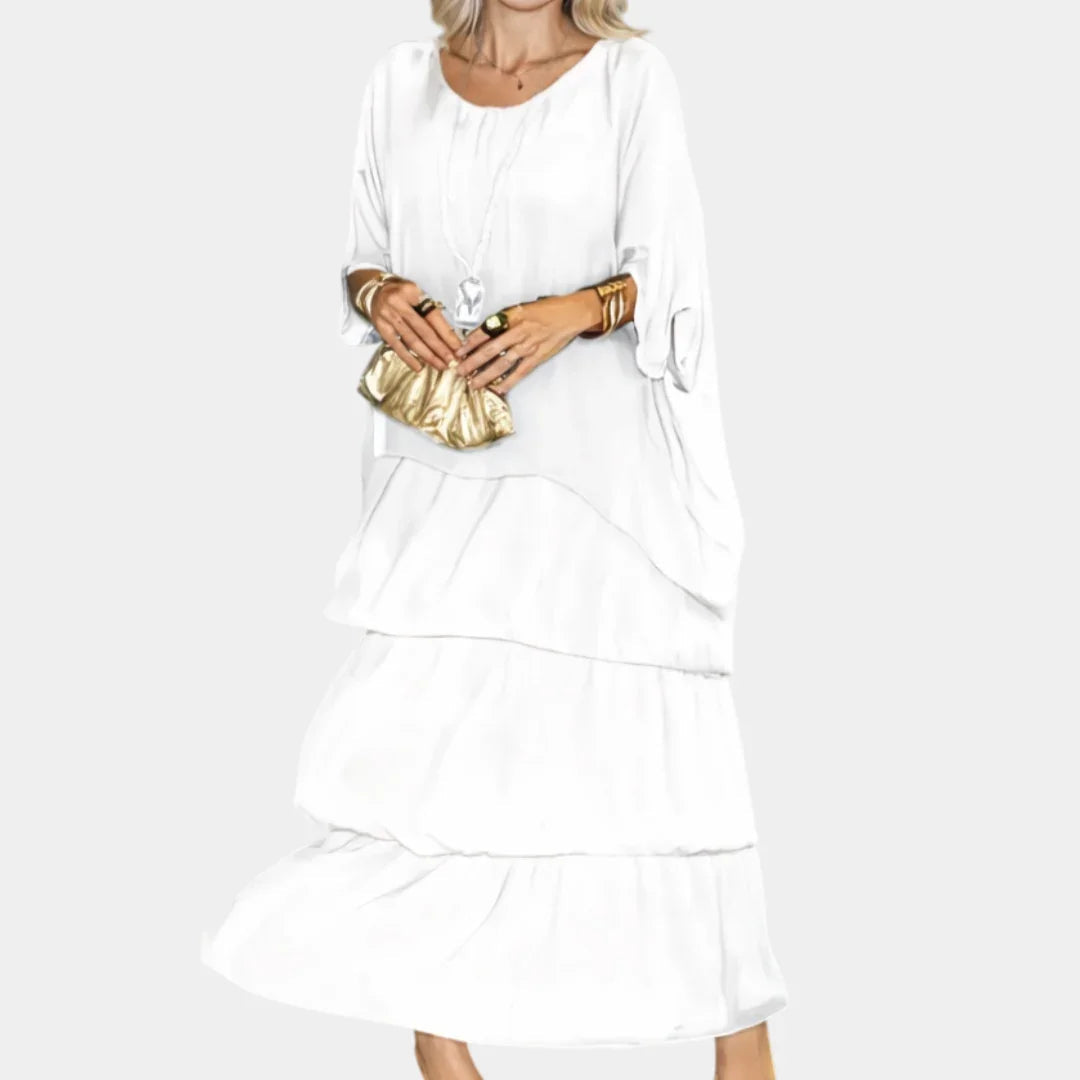 White tiered maxi dress with long sleeves and cascading ruffle layers