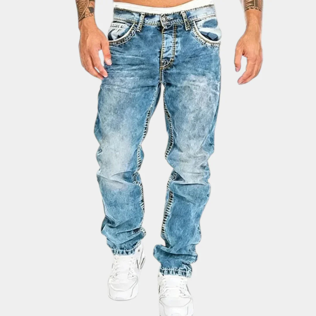 Light blue stretch jeans with distressed wash, five pockets, and cuffed ankle hem