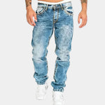 Light blue stretch jeans with distressed wash, five pockets, and cuffed ankle hem