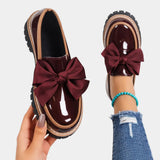 Burgundy heeled loafers with chunky sole and large burgundy bow detail