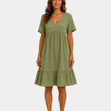 Green textured V-neck midi dress with short sleeves and tiered skirt