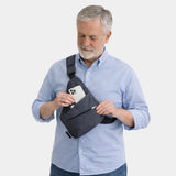 Dark anti-theft crossbody bag worn across chest with front pocket visible