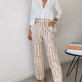 Two-piece outfit: white blouse with belt and cream pants with gray abstract swirl print