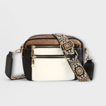 Two-tone small crossbody bag with white front panel and patterned fabric strap.
