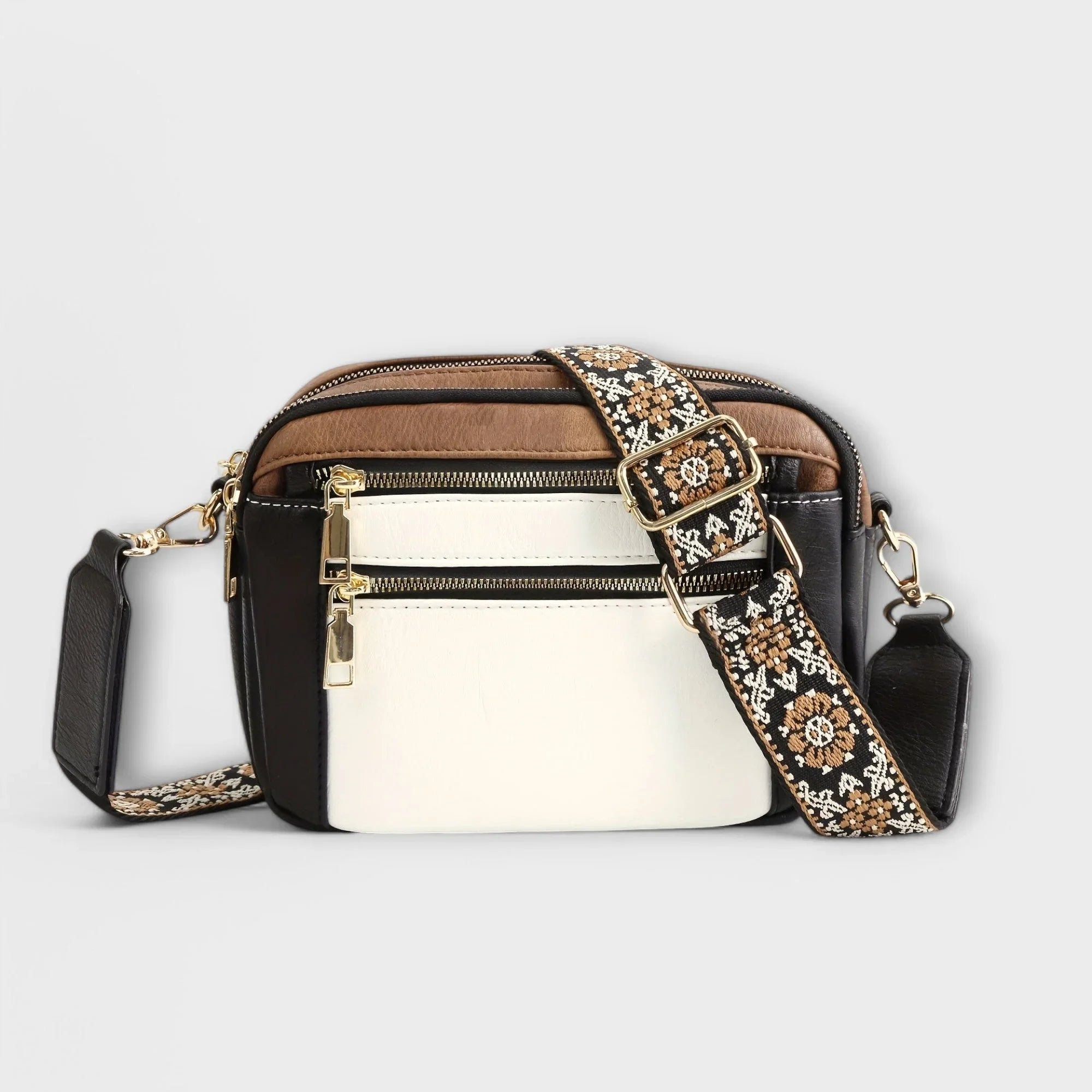 Two-tone small crossbody bag with white front panel and patterned fabric strap.