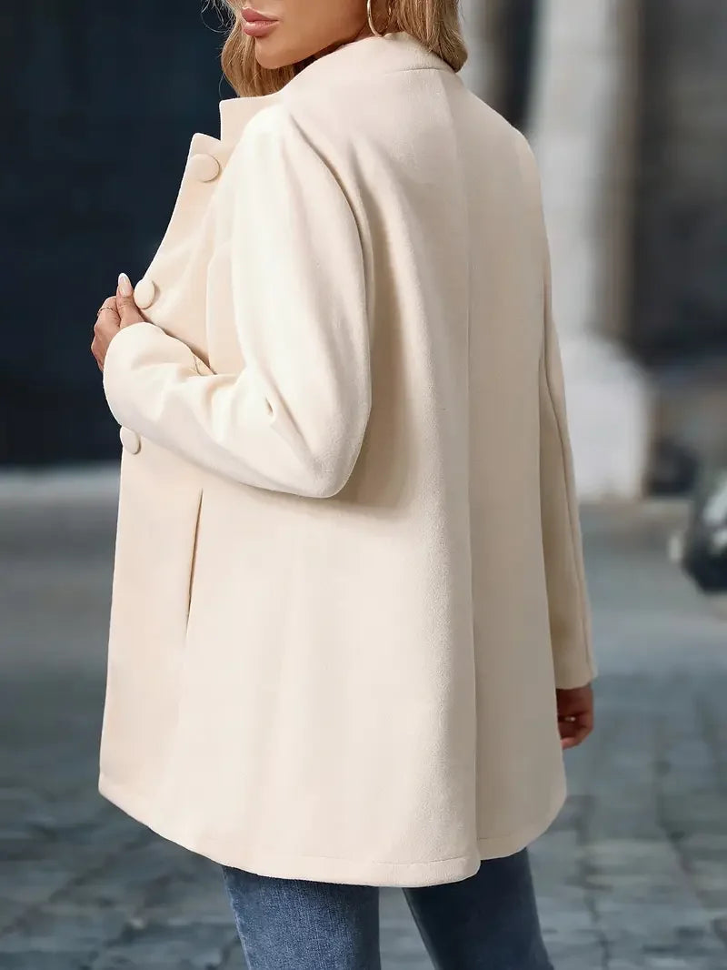 Cream button-front daily jacket with long sleeves and stand collar.