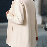 Cream button-front daily jacket with long sleeves and stand collar.