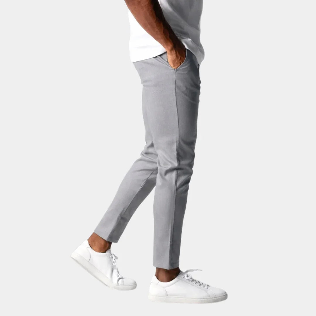 Light gray chino pants with button closure, front pockets, and tapered fit.