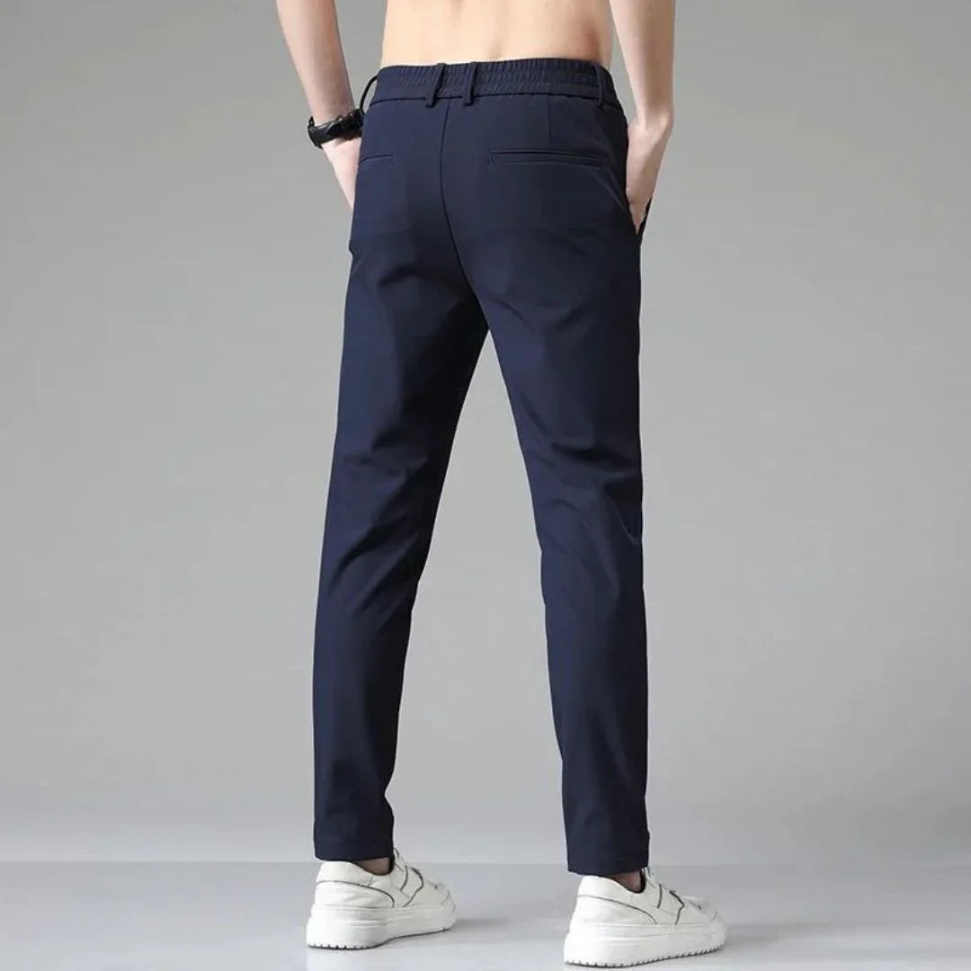 Men's navy blue slim-fit dress pants with belt loops and zip fly