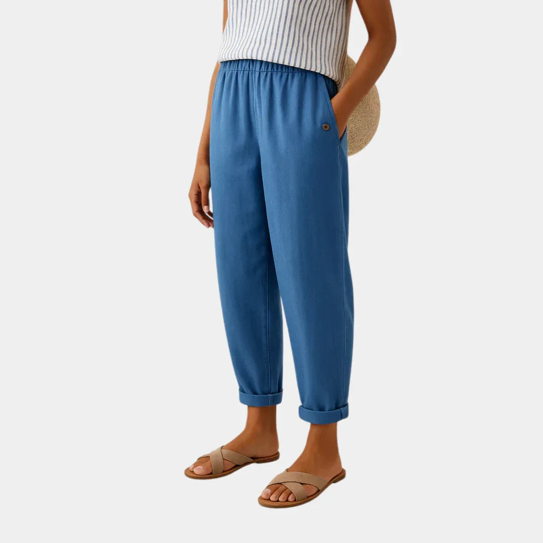 Blue linen-effect pants with elastic waist, button detail, and cuffed ankle hems
