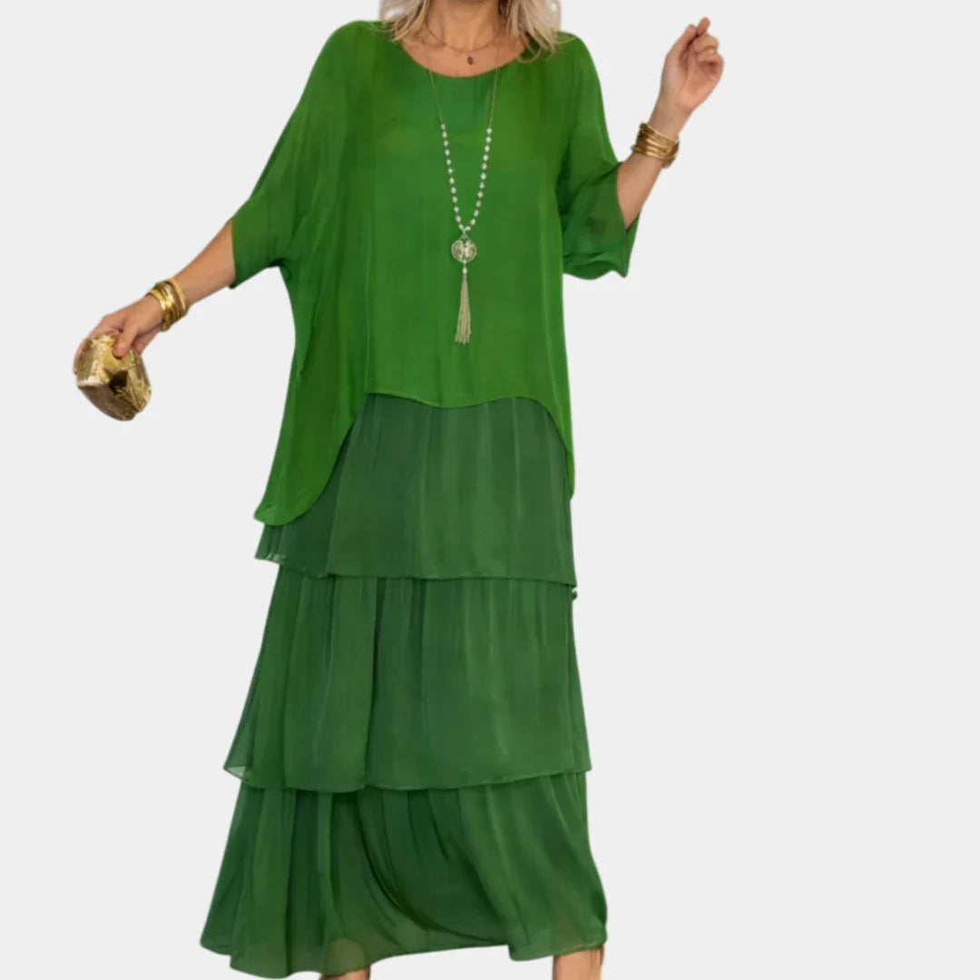Green tiered maxi dress with loose top, drop-style tiers, and flowing silhouette