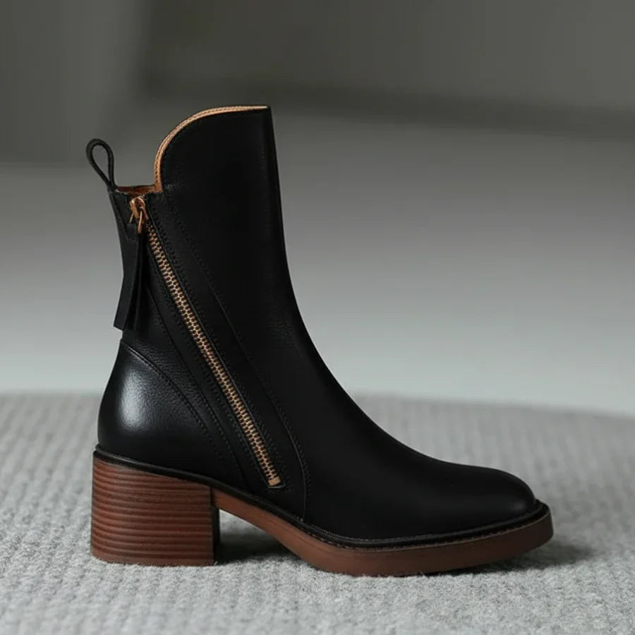 Black leather ankle boots with side zipper, brown heel and sole edge