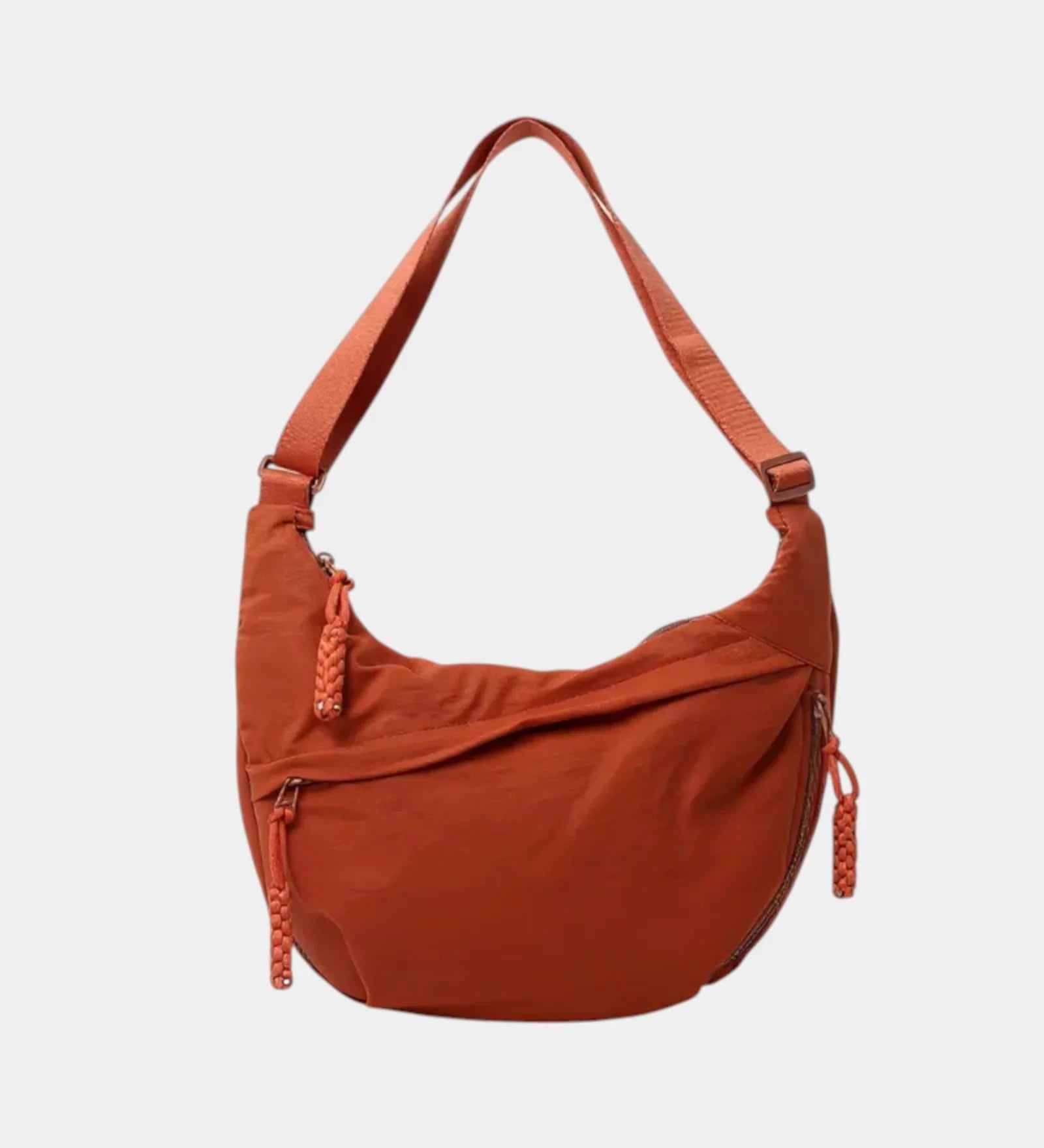 Orange anti-theft crossbody bag with curved hobo shape, adjustable strap, and side zipper.