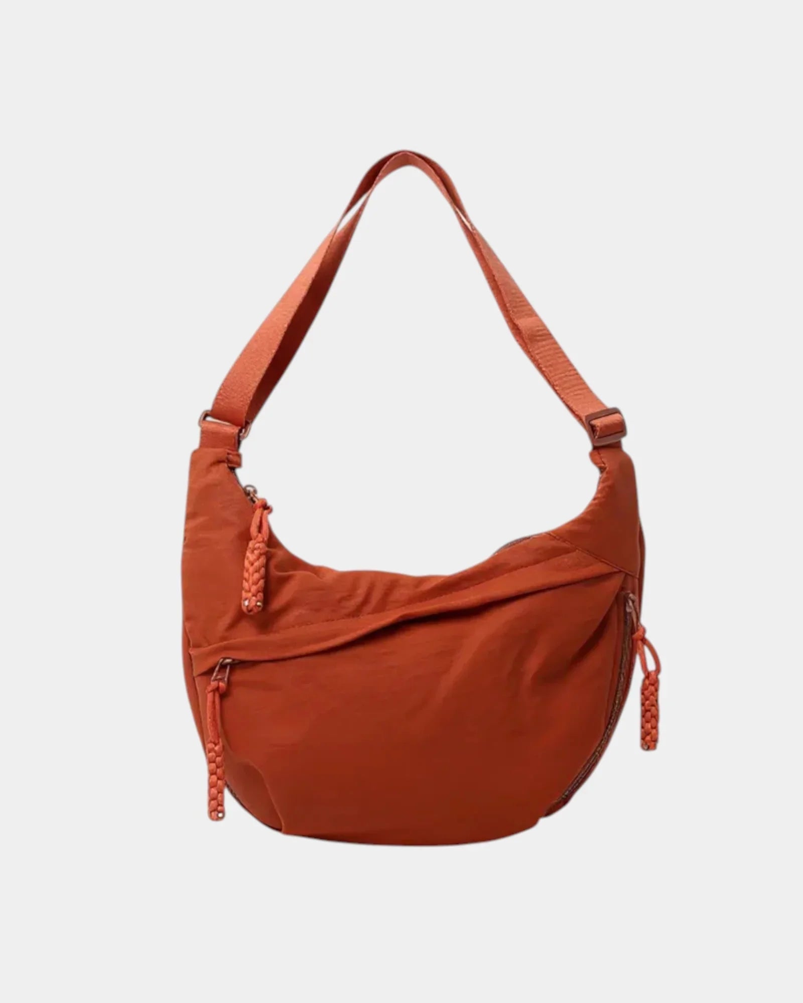 Orange anti-theft crossbody bag with curved hobo shape, adjustable strap, and side zipper.