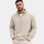 Beige ribbed quarter-zip sweater with long sleeves and short half-zip placket