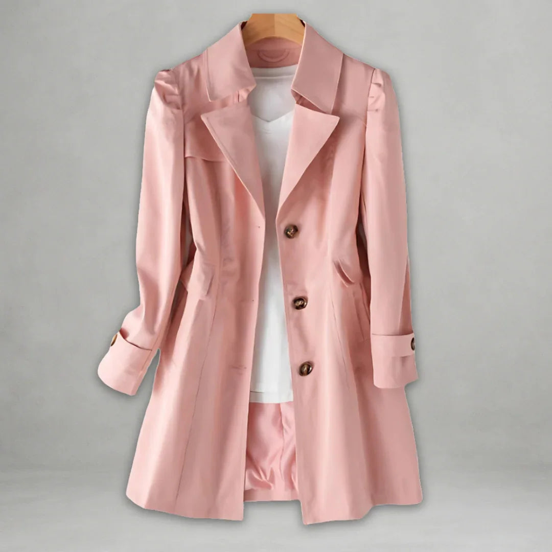 Pink spring trench coat with double-breasted buttons, notched lapels, and cuff tabs