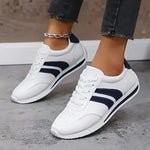 White lightweight orthopedic sneakers with navy stripe accents, lace-up design