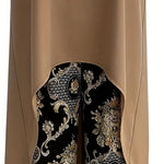 Taupe sleeveless tunic featuring a curved hem over black gold paisley wide-leg pants