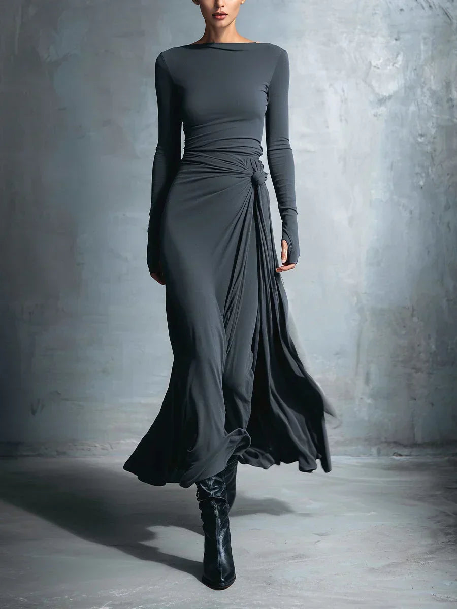 Charcoal gray long-sleeve draped maxi dress with ruched waist and flowing side wrap