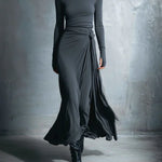 Charcoal gray long-sleeve draped maxi dress with ruched waist and flowing side wrap