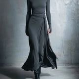 Charcoal gray long-sleeve draped maxi dress with ruched waist and flowing side wrap