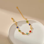 Gold-tone heart charm bracelet with multicolor enamel heart stones