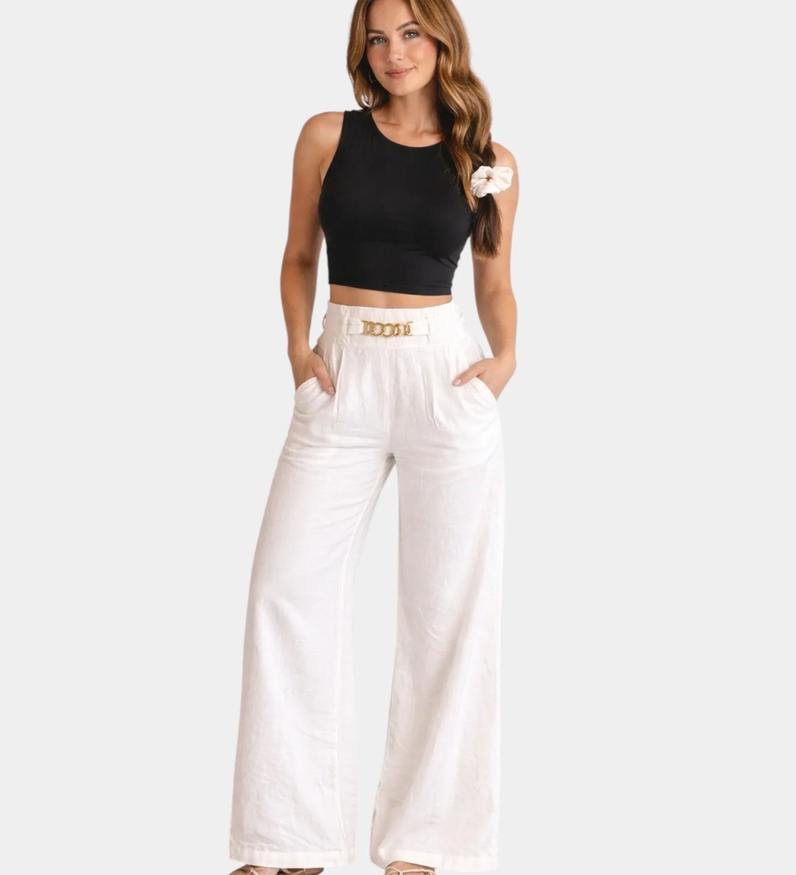 White high-waist wide-leg pants with gold chain belt detail