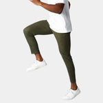 Olive green chino pants with slim tapered fit and button front, ankle length.