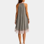 Back view of gray sleeveless halter dress with lace trim hem