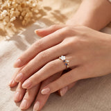 Gold-tone ring with white flower center and clear stone petals