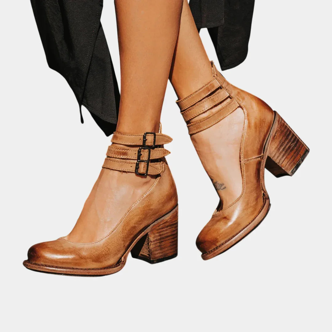 Brown ankle-strap block heel shoes with two buckled straps, chunky heel, pointed toe