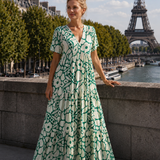 Green floral maxi dress with V-neck, short sleeves, and tiered maxi skirt